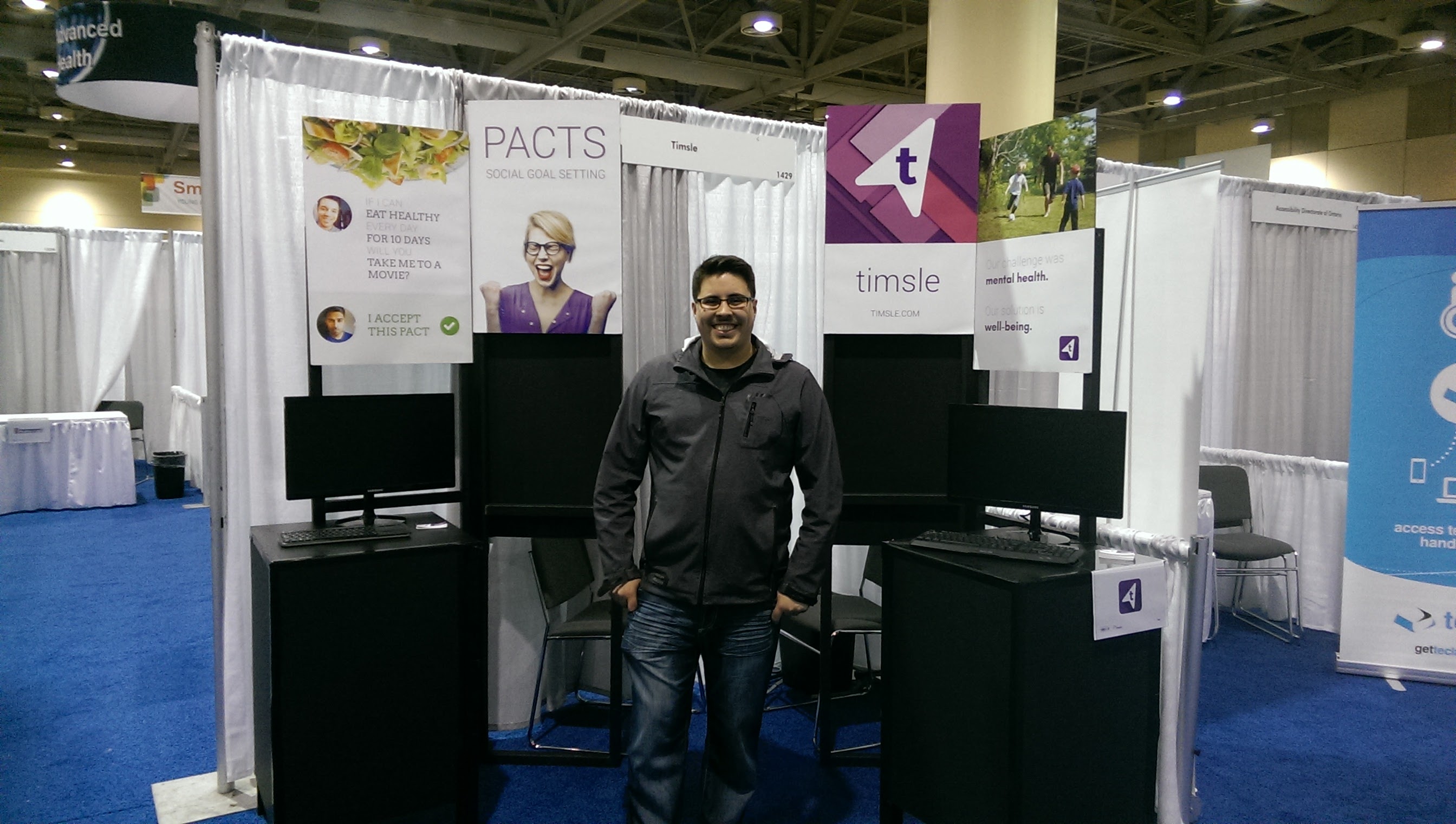 Jacob Hooey in front of the Timsle booth at the Ontario Centre of Excellence: Discovery conference